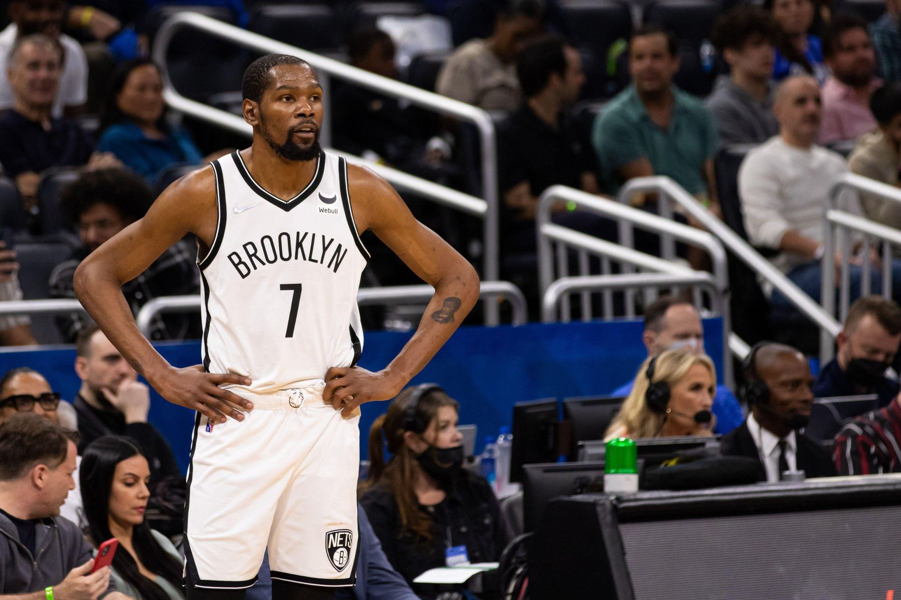 Professional basketball player standing courtside
