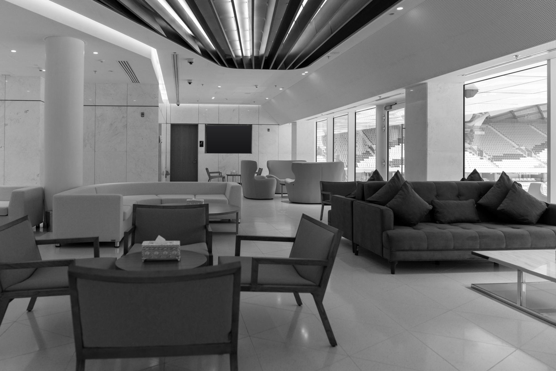 Private stadium lounge with armchairs and a view over the pitch